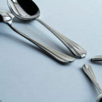 The flatware has an art deco style handle.