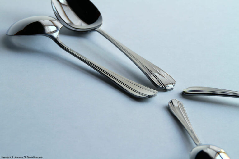 The flatware has an art deco style handle.