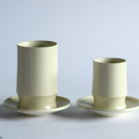 Une, Cup and tumbler on saucers.