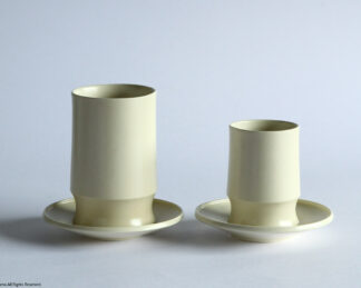 Une, Cup and tumbler on saucers.